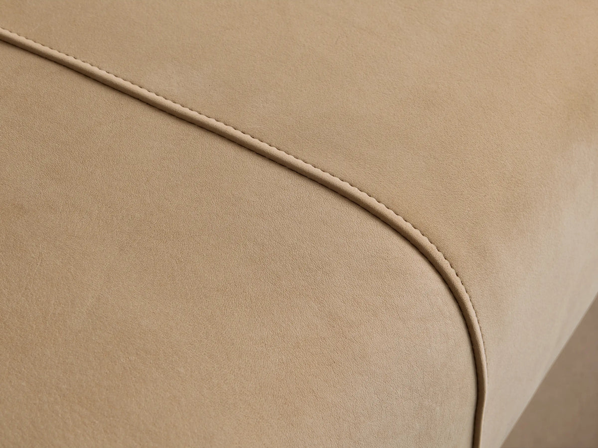 A long, rectangular Tilton Leather Bench in light cream, with two vertical seams on the top surface and thin gold metallic legs.