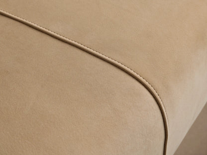 A long, rectangular Tilton Leather Bench in light cream, with two vertical seams on the top surface and thin gold metallic legs.
