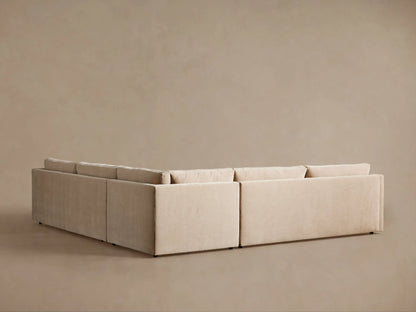 Angled close-up of light beige Kipton Slope Arm Sectional, showing soft cushions and gently sloping armrest.