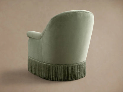 Front view of the sage green Augustus Swivel Chair with Fringe, featuring a curved back, rolled arms, and long fringe.