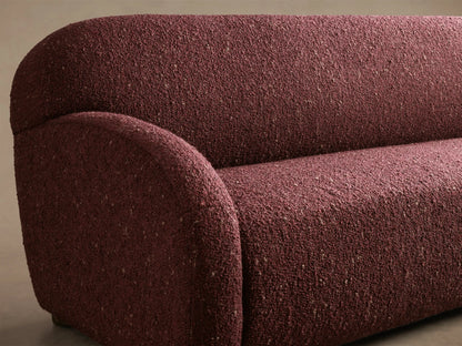 Front view of the burgundy speckled Algiers Sofa with a modern, rounded silhouette and armrests.