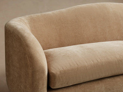 Ashlyn Two-Seat Sofa in light beige upholstered fabric, featuring a curved back and two soft seat cushions.