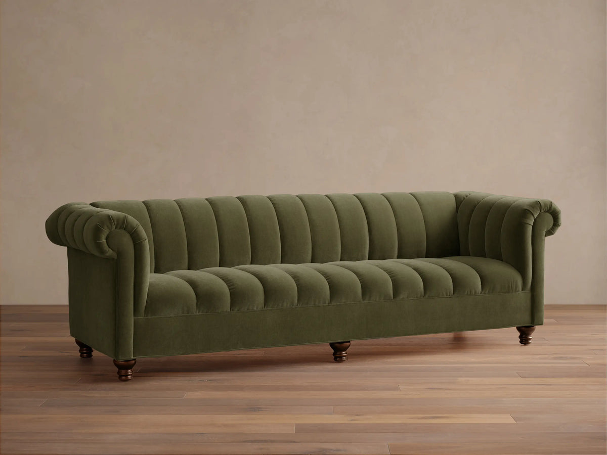 Front view of the olive green Berwick Channeled Sofa with channel-stitched back and seat, rolled arms, and turned wooden legs.