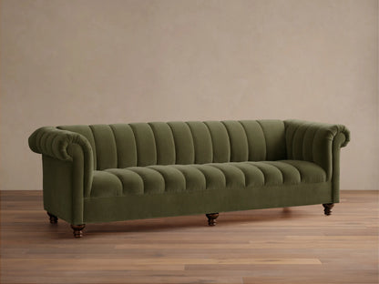 Front view of the olive green Berwick Channeled Sofa with channel-stitched back and seat, rolled arms, and turned wooden legs.