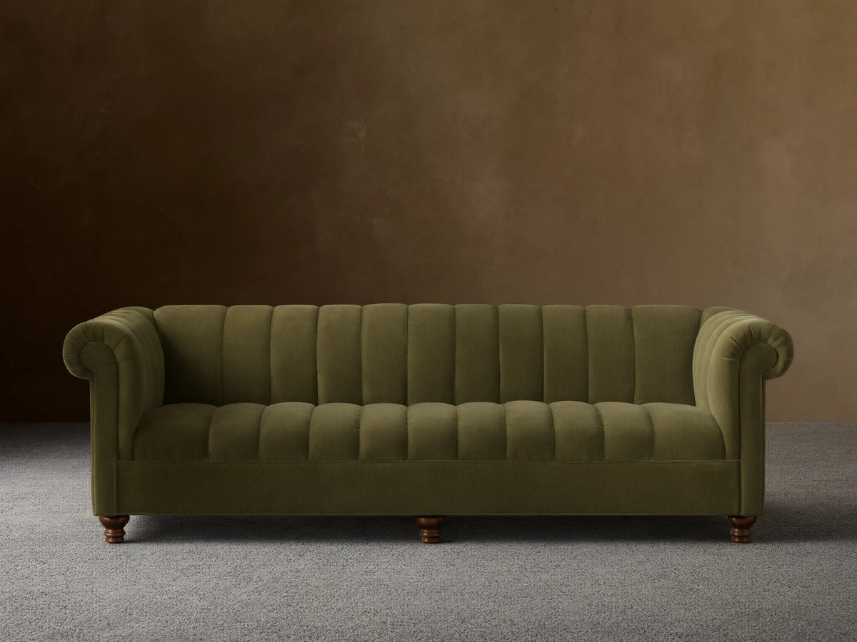 Front view of the olive green Berwick Channeled Sofa with channel-stitched back and seat, rolled arms, and turned wooden legs.