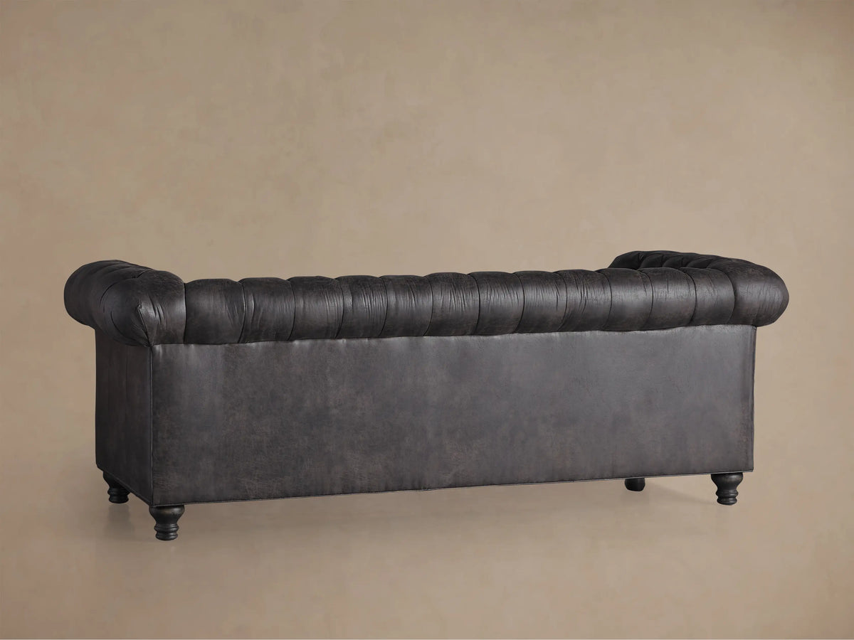 Berwick Faux Leather Sofa, dark charcoal with distressed look, tufted back & seat, rolled arm with nailhead trim.