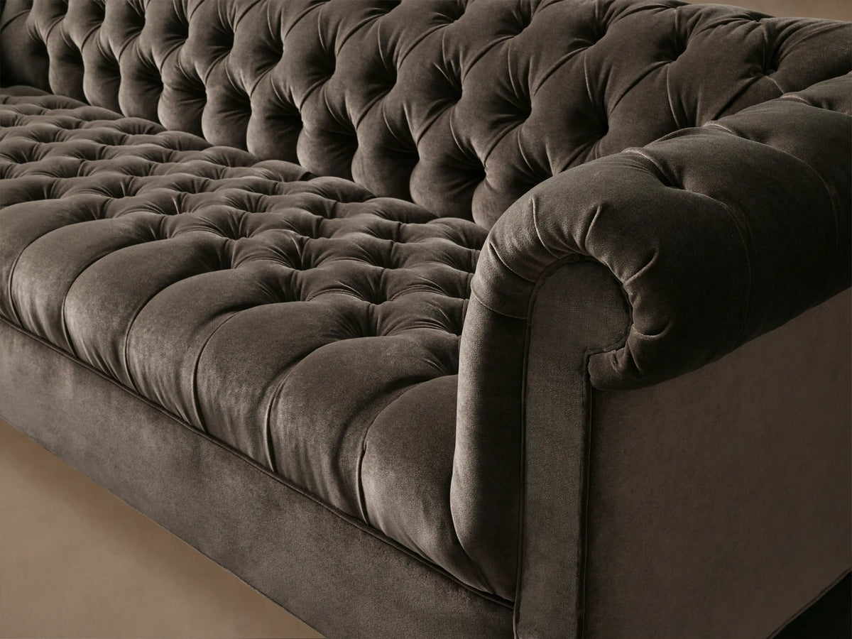 Berwick Sofa, dark mink tufted velvet sofa with rolled arms and turned wooden legs, on a light wood floor.