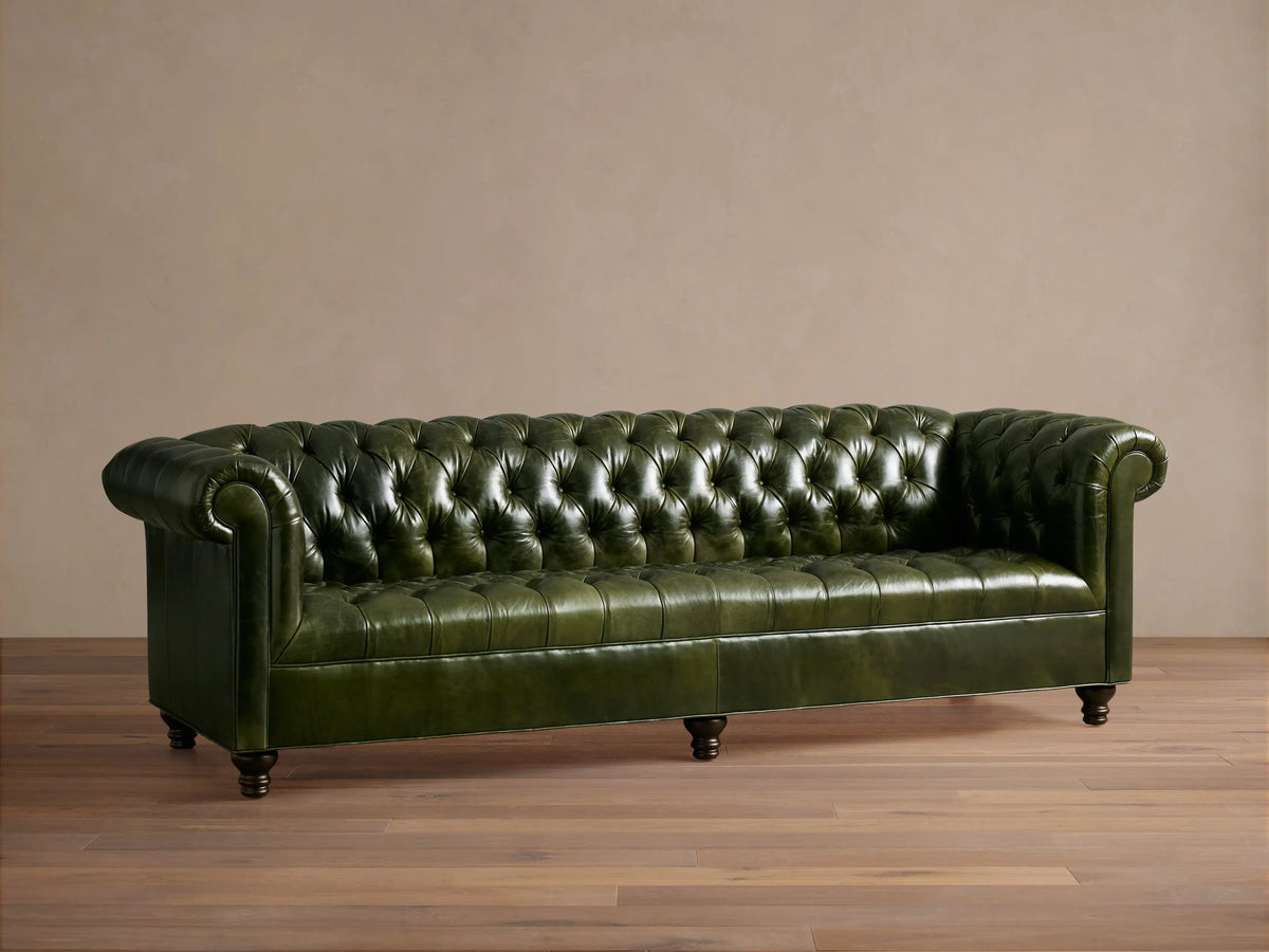 Classic Berwick Leather Sofa in deep green, Chesterfield style with tufted back, rolled arms, and dark wood legs.