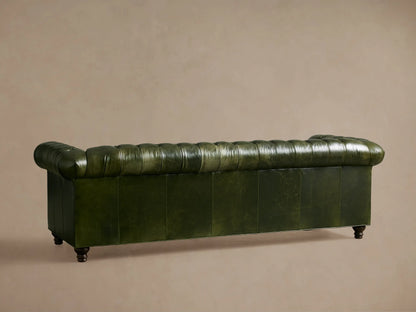 Berwick Leather Sofa, deep green tufted leather with classic rolled arm, showing dark carved leg.