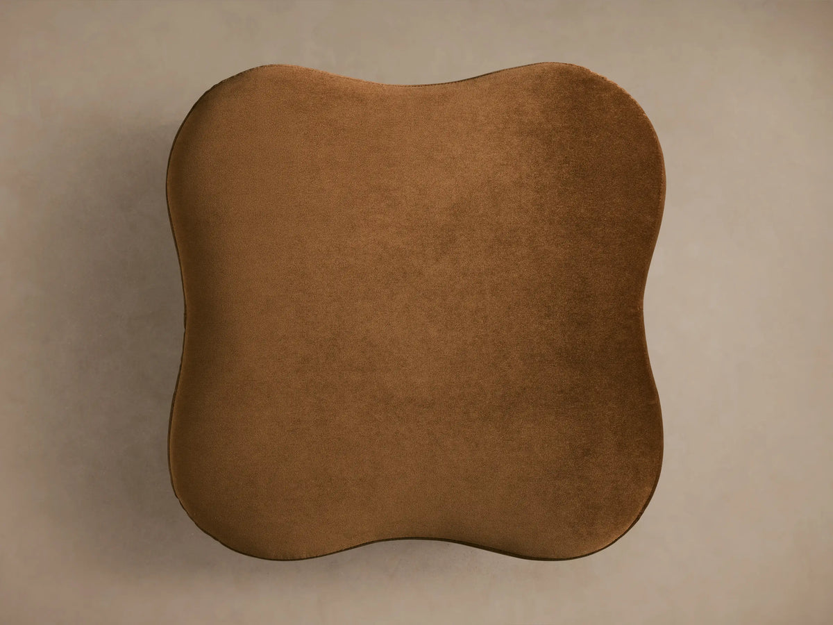 Top-down view of a plush brown Barbey Ottoman with an organic, irregular shape.