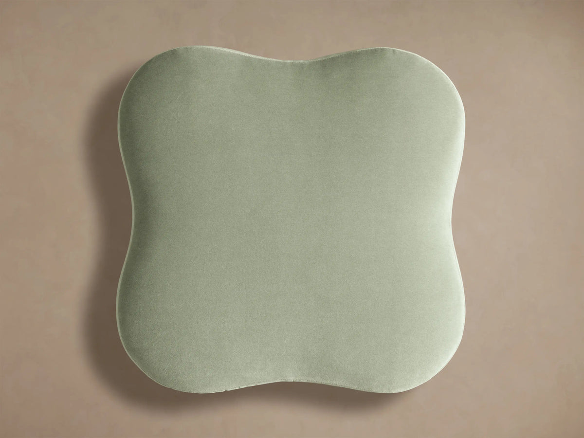Top view of light sage green Barbey Ottoman with Fringe, showcasing its rounded, irregular cushion surface.