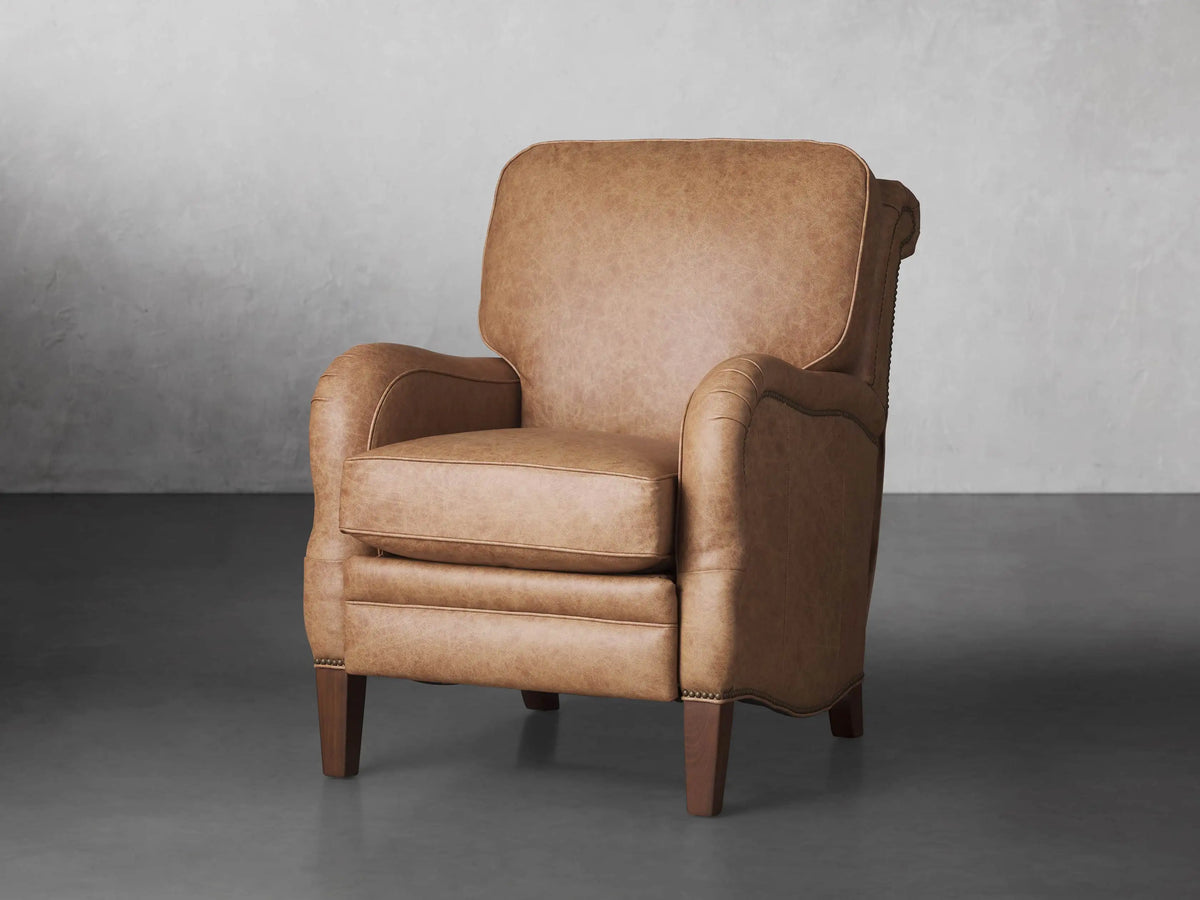 Brooklyn Leather Recliner in warm tan. Front view, slightly angled, showing soft, textured leather, rolled arms, and tapered wooden legs.