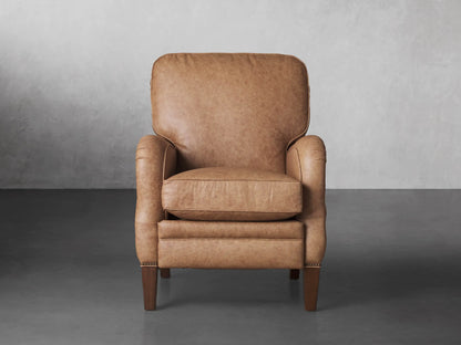 Brooklyn Leather Recliner in warm tan. Front view, slightly angled, showing soft, textured leather, rolled arms, and tapered wooden legs.