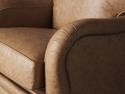 Front view of a Brooklyn Leather Recliner. Light brown, natural leather with padded seat and arms, dark wood legs.