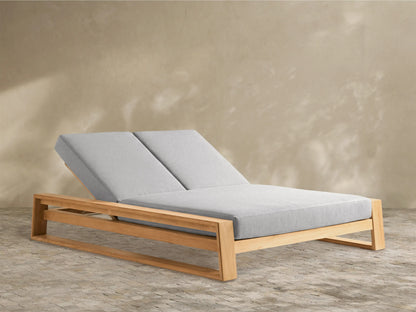 Canyon Outdoor Teak Double Chaise with two adjustable backrests and light grey cushions on a natural teak frame, angled right.