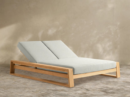 Canyon Outdoor Teak Double Chaise with natural teak wood frame and light grey cushions. Both adjustable backrests are angled up.