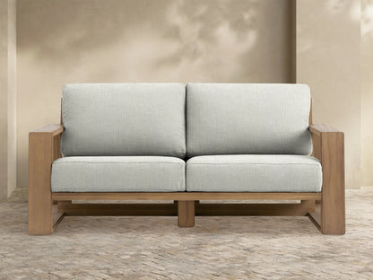 Canyon Outdoor Teak Sofa, front view. Two-seater with natural teak wood frame and light grey fabric cushions.