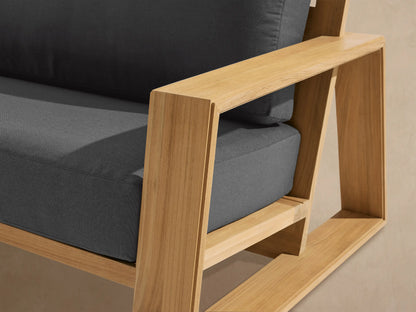 Front view of the Canyon Outdoor Teak Sofa with natural teak wood frame and charcoal cushions.
