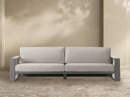 Canyon Outdoor Aluminum Sofa. Front view of a modern sofa with a dark gray aluminum frame and two light beige fabric cushions.
