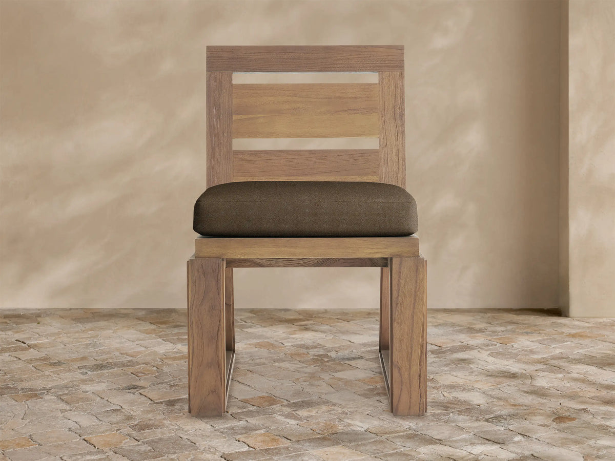Front view of Canyon Outdoor Teak Dining Side Chair with natural teak wood frame, slatted back, and a dark brown seat cushion.