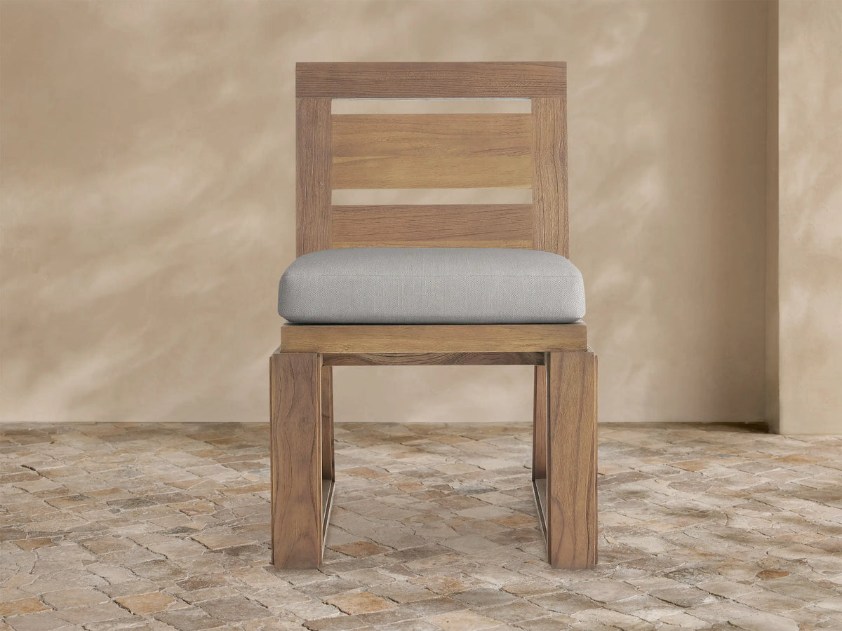 Canyon Outdoor Teak Dining Side Chair, front view, natural brown teak wood with slatted backrest and light grey cushion.