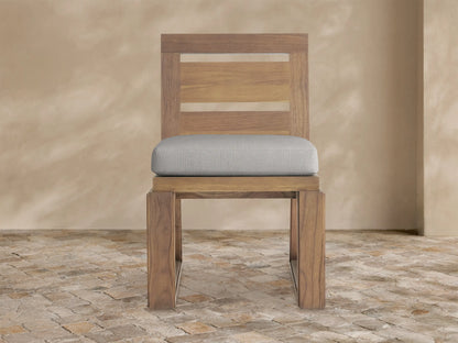 Canyon Outdoor Teak Dining Side Chair, front view, natural brown teak wood with slatted backrest and light grey cushion.