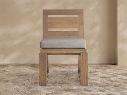 Front view of Canyon Outdoor Teak Dining Side Chair, natural brown wood, slatted back, light grey cushion, U-shaped base.