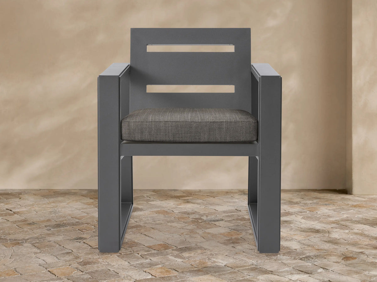 Front view of a dark gray Canyon Outdoor Aluminum Dining Arm Chair with two horizontal back slats and a mottled brown seat cushion.