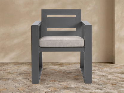 Canyon Outdoor Aluminum Dining Arm Chair, front view. Dark gray frame, rectangular arms, slatted backrest, light beige cushion.