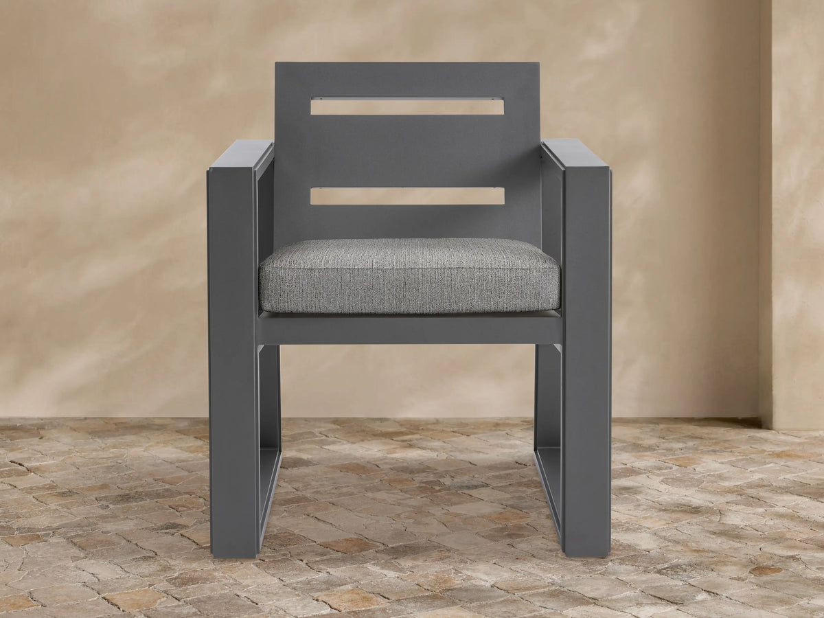 Front view of Canyon Outdoor Aluminum Dining Arm Chair, dark gray with two horizontal slats on the back and a light gray seat cushion.