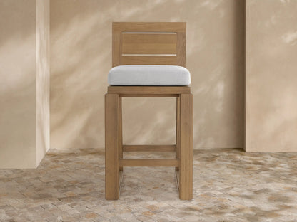 Canyon Outdoor Teak Barstool, front view, light brown teak wood frame with a light gray cushion and two-slat backrest.