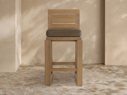 Canyon Outdoor Teak Barstool, front view. Natural teak wood frame with slatted backrest & plush dark brown cushion.