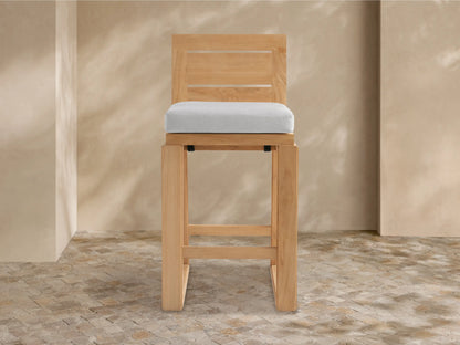 Canyon Outdoor Teak Barstool with light brown wood frame, slatted backrest, and light gray cushion, shown front view.