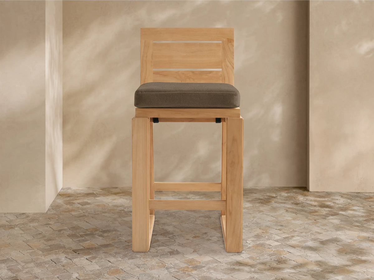 Front view of Canyon Outdoor Teak Barstool, light natural wood frame, slatted back, sturdy square legs, dark brown cushion.