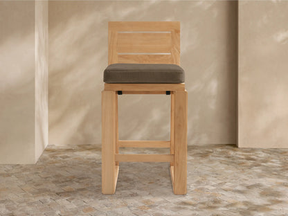 Front view of Canyon Outdoor Teak Barstool, light natural wood frame, slatted back, sturdy square legs, dark brown cushion.