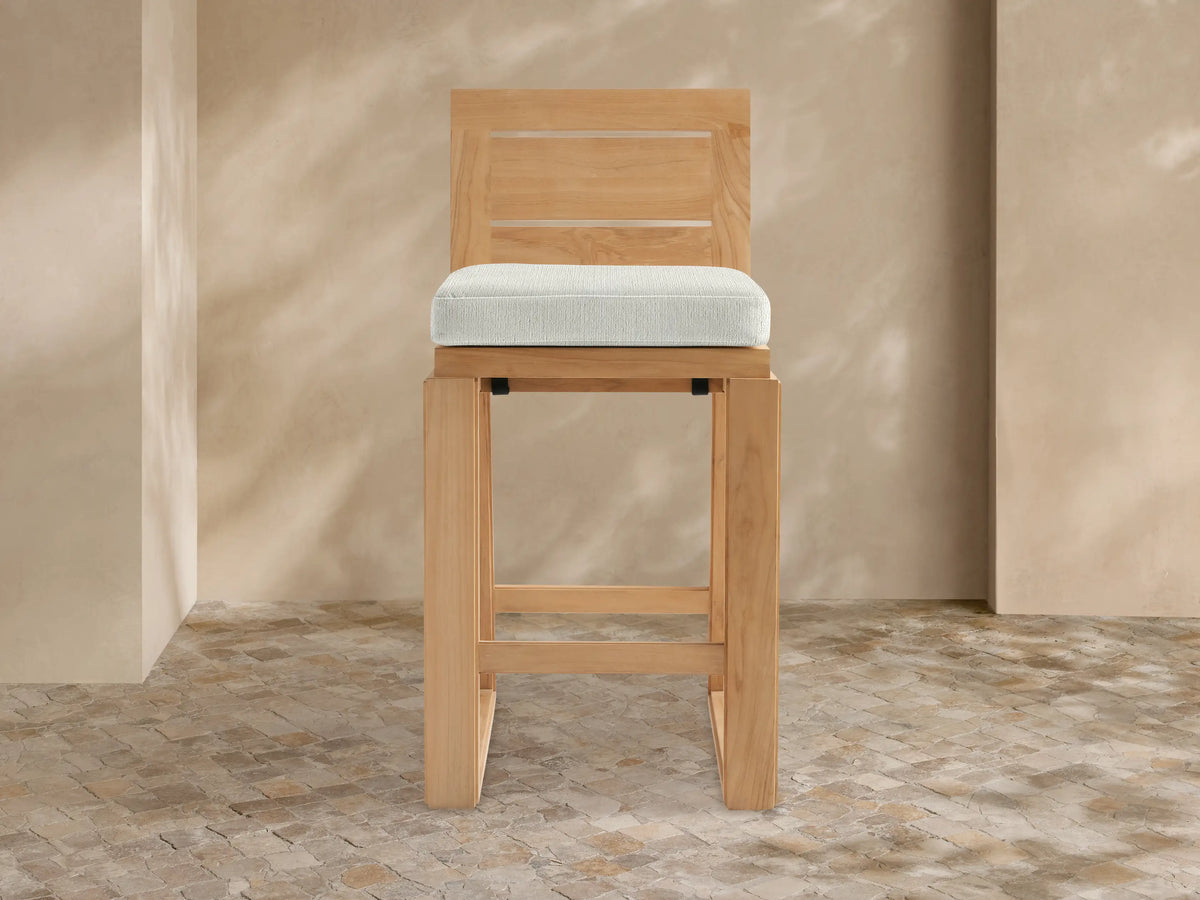 Canyon Outdoor Teak Barstool, natural teak wood, rectangular slatted back, light grey cushion, front view.