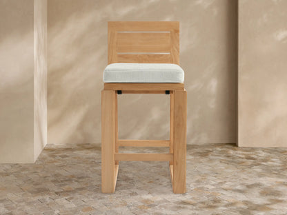 Canyon Outdoor Teak Barstool, natural teak wood, rectangular slatted back, light grey cushion, front view.