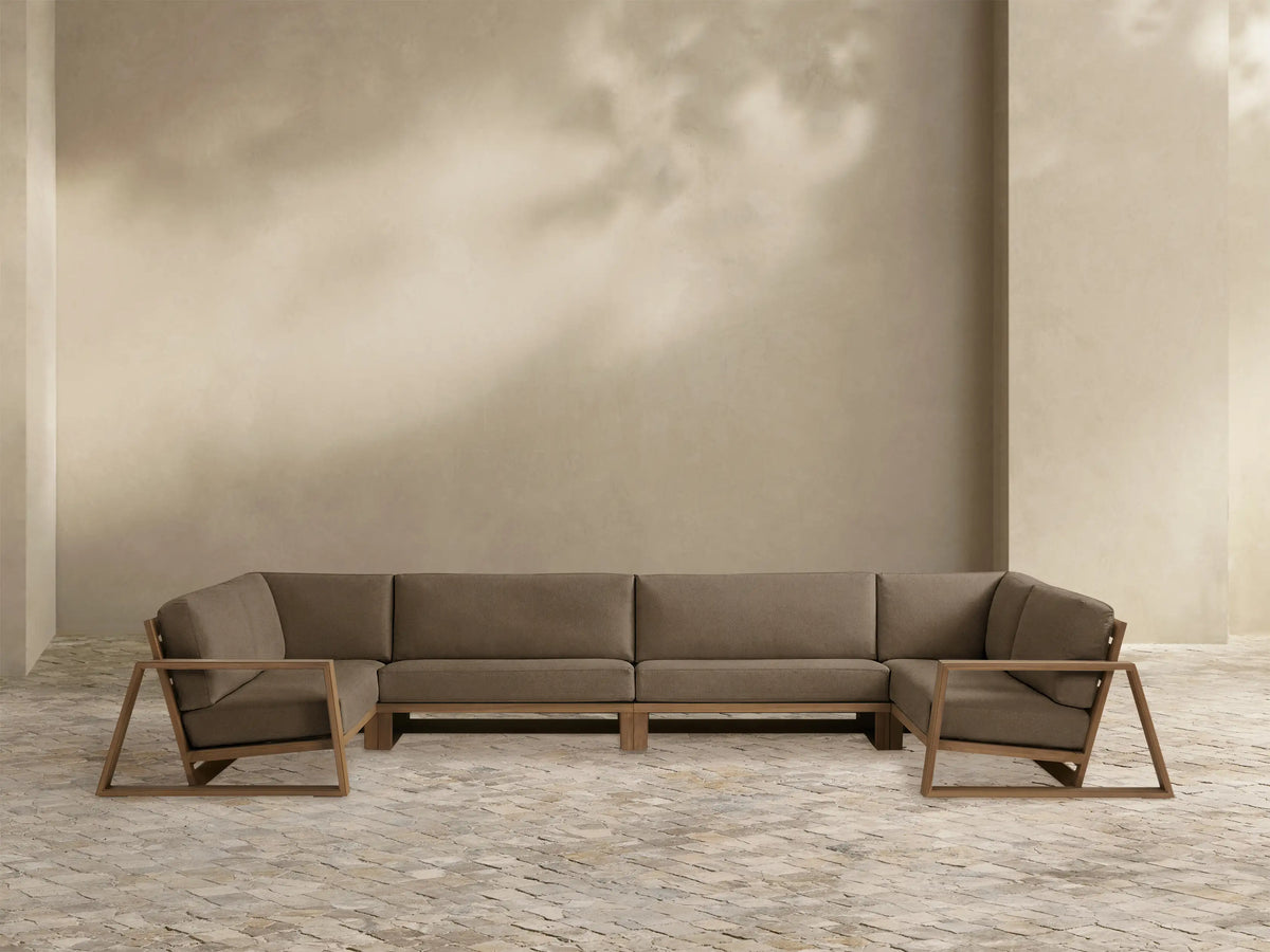 Canyon Outdoor Teak Sectional: U-shaped, medium brown teak frame with open geometric armrests, dark brown cushions, white background.