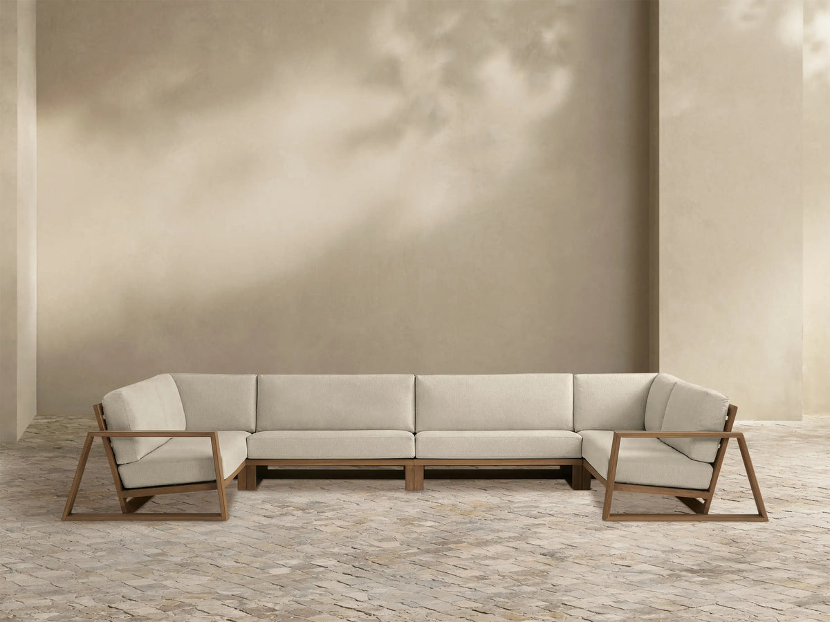 Canyon Outdoor Teak Four-Piece Sectional: U-shaped with light beige cushions and natural teak wood open-frame armrests.