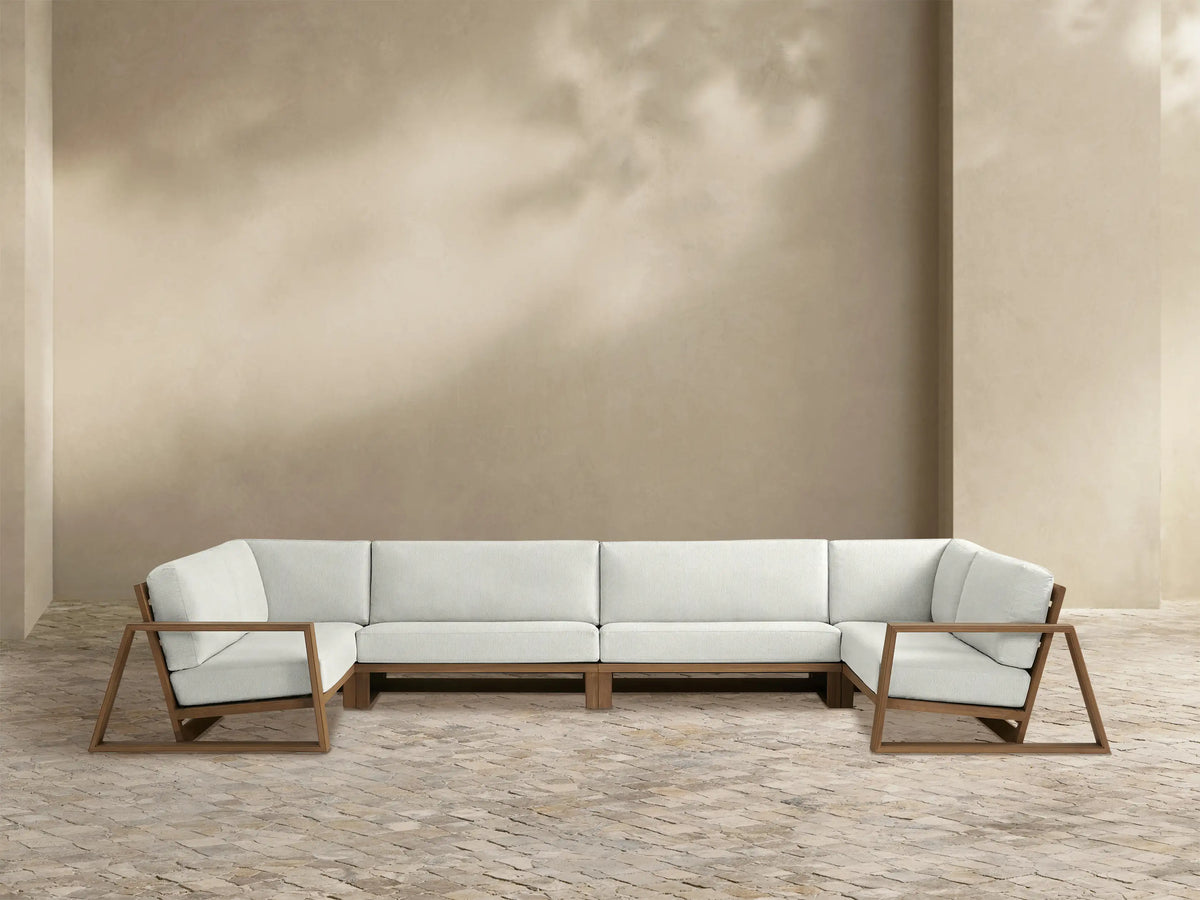 Canyon Outdoor Teak Four-Piece Sectional, L-shaped, with weathered fawn wood frame and white cushions.