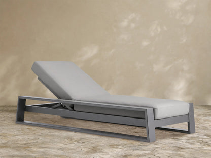 Canyon Outdoor Aluminum Chaise, dark gray aluminum frame with light gray cushion, reclined, viewed from a slight angle.