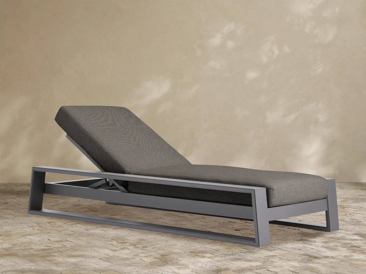 Canyon Outdoor Aluminum Chaise, dark gray aluminum frame with charcoal fabric cushions, backrest reclined, angled view.