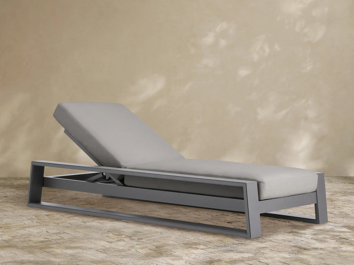 Canyon Outdoor Aluminum Chaise, dark grey frame, light grey cushions. Modern design, backrest elevated. Product shot.