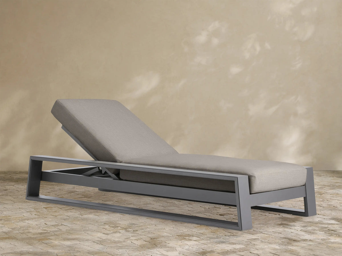 Canyon Outdoor Aluminum Chaise with dark gray aluminum frame and light gray cushions, backrest elevated, angled right on white.