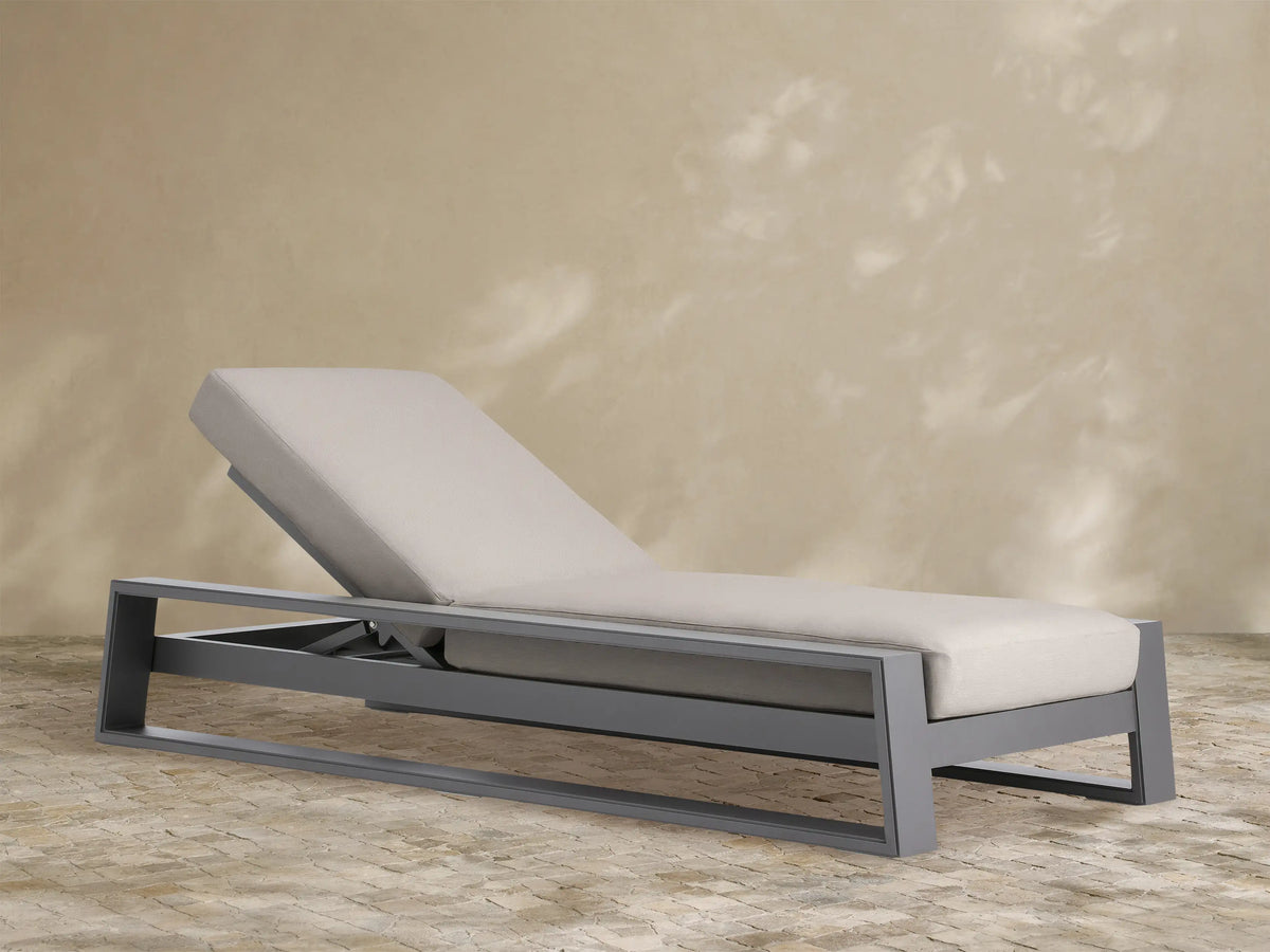 Canyon Outdoor Aluminum Chaise with a dark gray aluminum frame and light beige cushions, shown with the backrest raised.