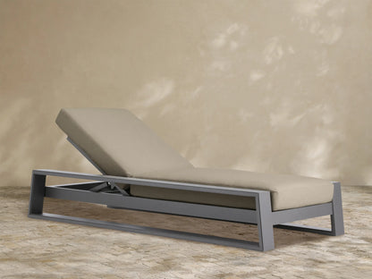 Canyon Outdoor Aluminum Chaise with dark gray frame and tan cushions, backrest raised, angled view against white background.