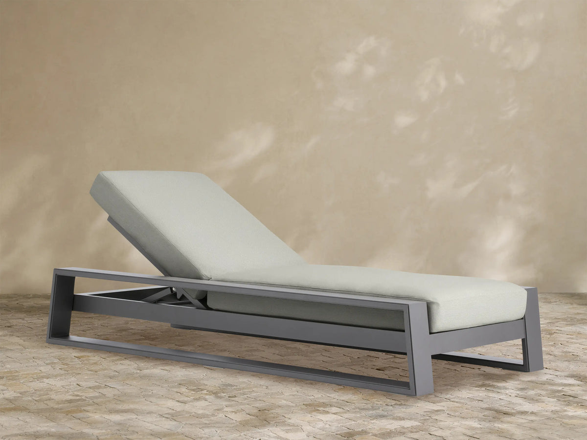Canyon Outdoor Aluminum Chaise, dark grey aluminum frame, light grey cushion, reclined backrest, angled view on white.