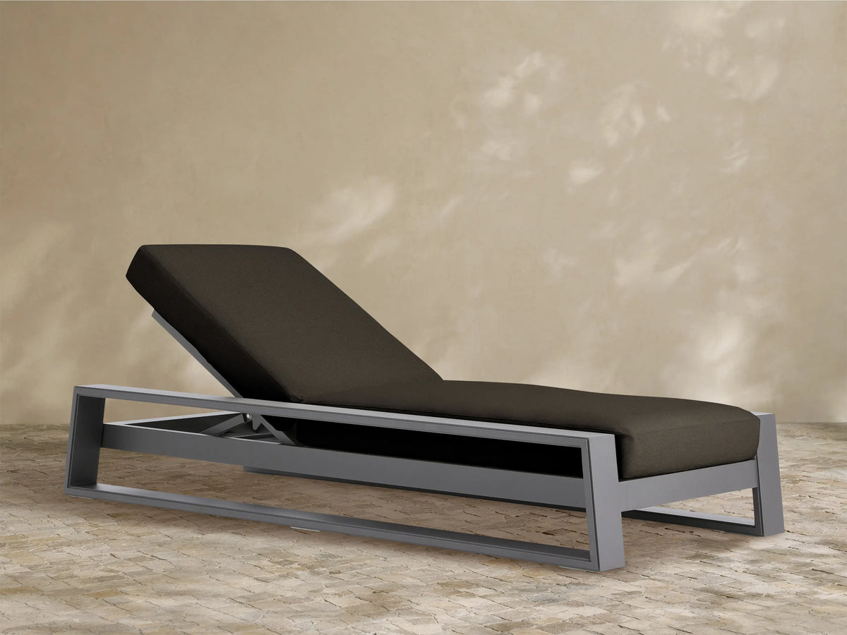 Canyon Outdoor Aluminum Chaise: gray frame, dark brown cushions, elevated backrest, angled right on white.