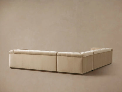 Angled view of a light beige Cameran Three-Piece Sectional, with soft, button-tufted seats & back.