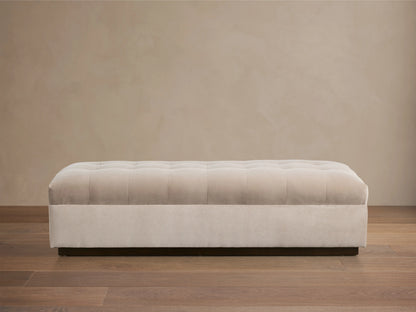 Tan, rectangular Cameran Bench with a tufted design and soft fabric texture, viewed from above against a beige background.